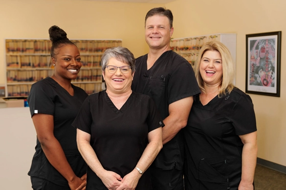 Chiropractor Florence AL Charles Corfman With Team 1 Dr. Charles Corfman smiling with his team.